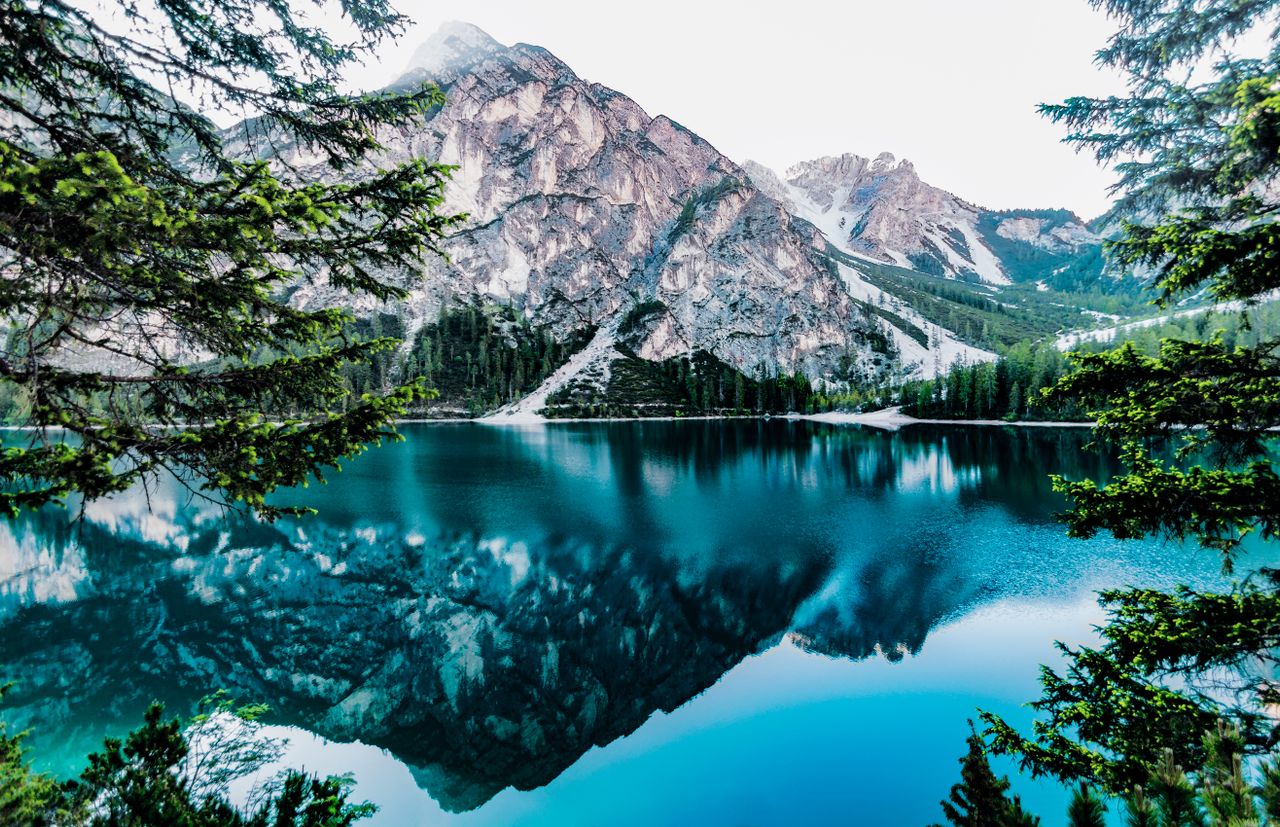 Mountain lake framed by evergreen trees and rocky peaks