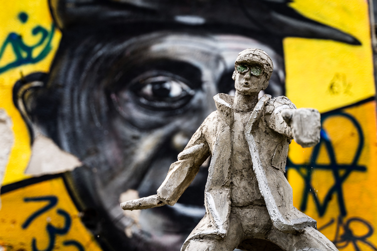 Small clay figure with a large painted eye behind it at Metelkova