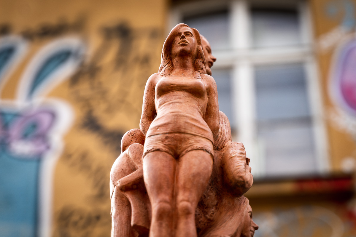 Terracotta-coloured female sculpture photographed at Metelkova