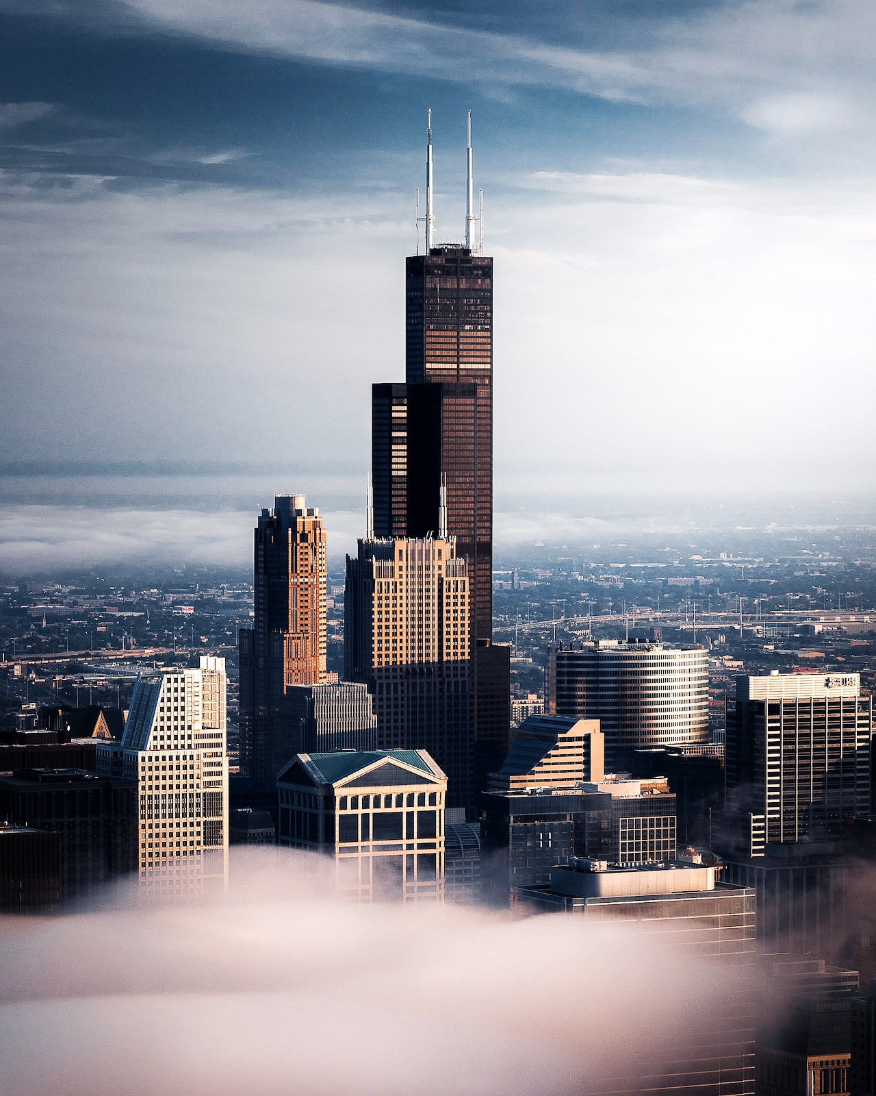 Willis Tower rising above surrounding buildings, with its stepped structural form clearly visible