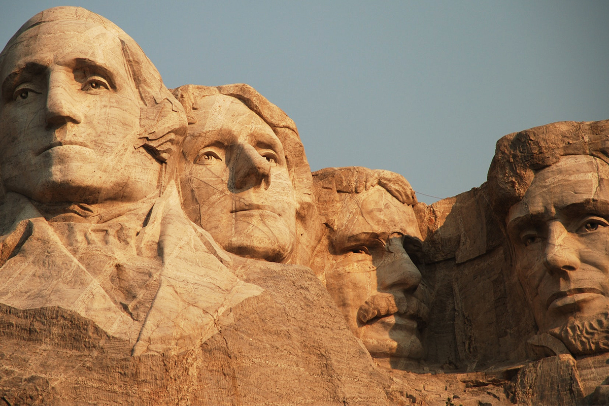 Close view of the four Mount Rushmore portraits in warm late-day light
