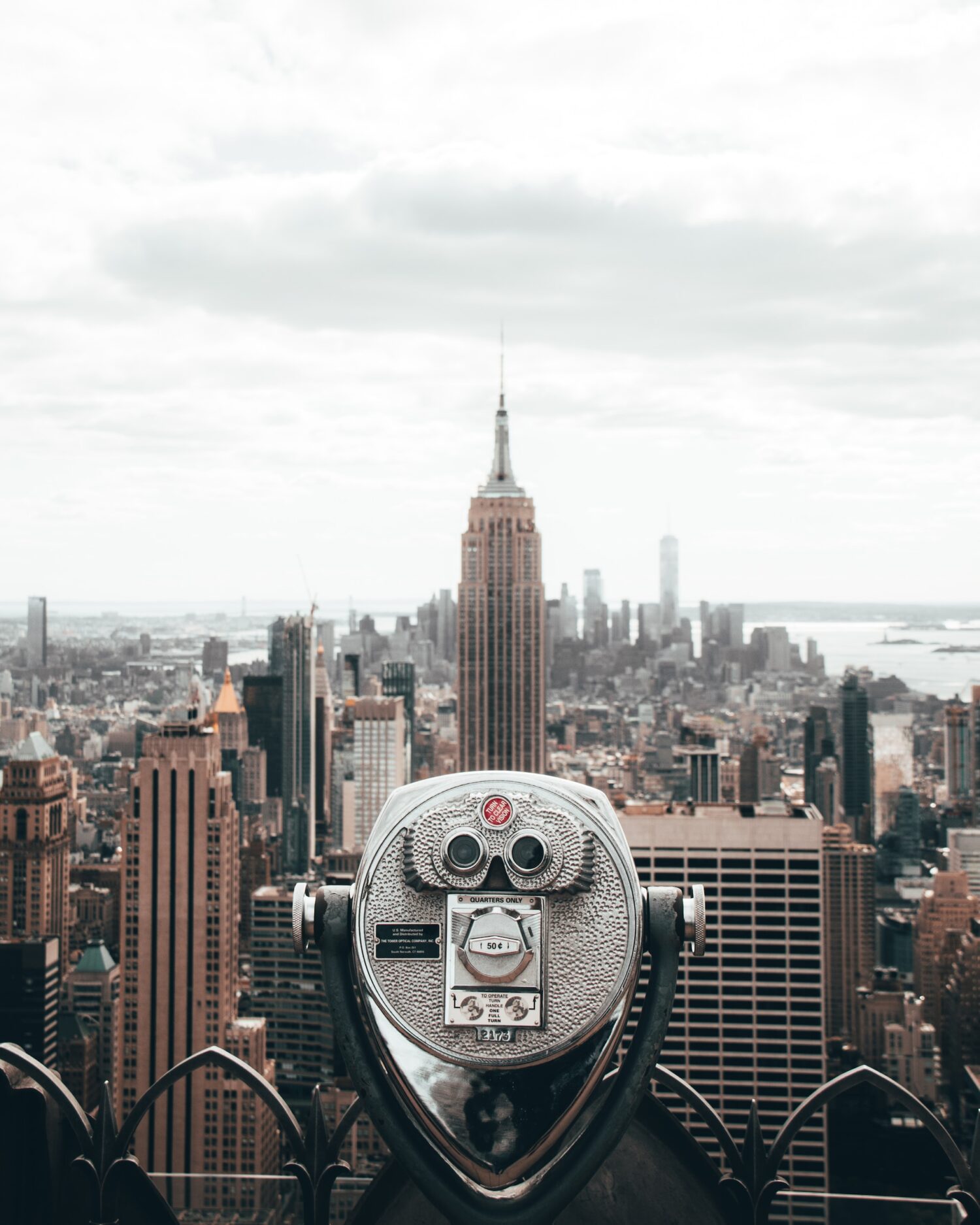 Empire State Building seen from Rockefeller Center with an observation binocular in the foreground