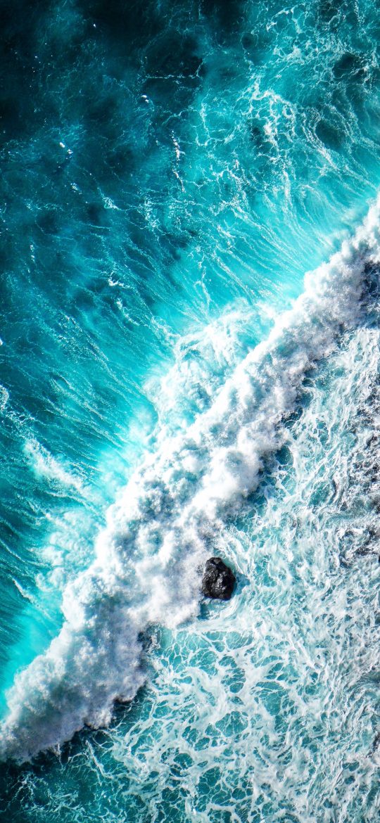 Aerial iPhone wallpaper showing white surf breaking across deep turquoise water