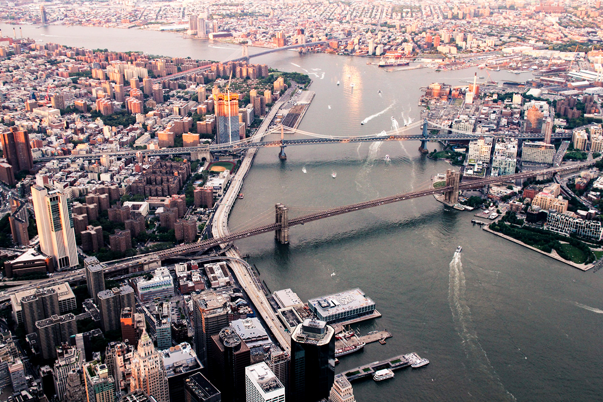 An elevated view across the Brooklyn Bridge and the East River