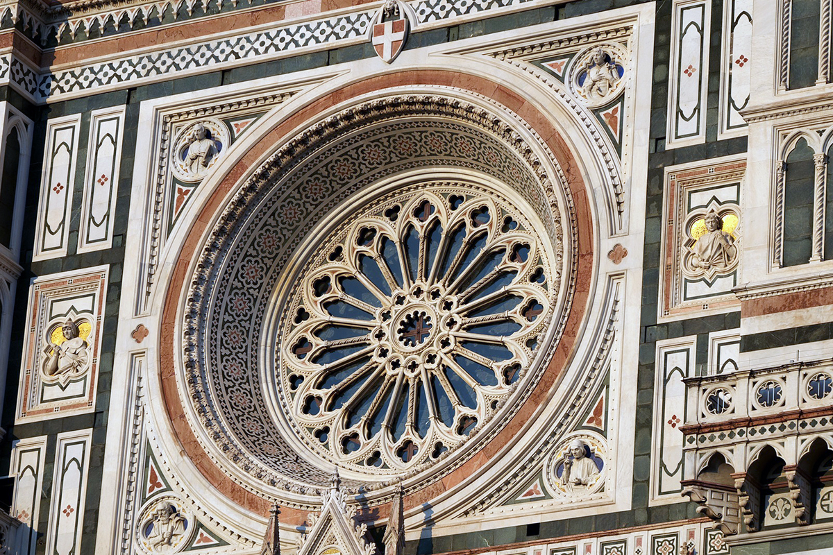 A close view of the rose window and sculpted marble façade of Florence Cathedral