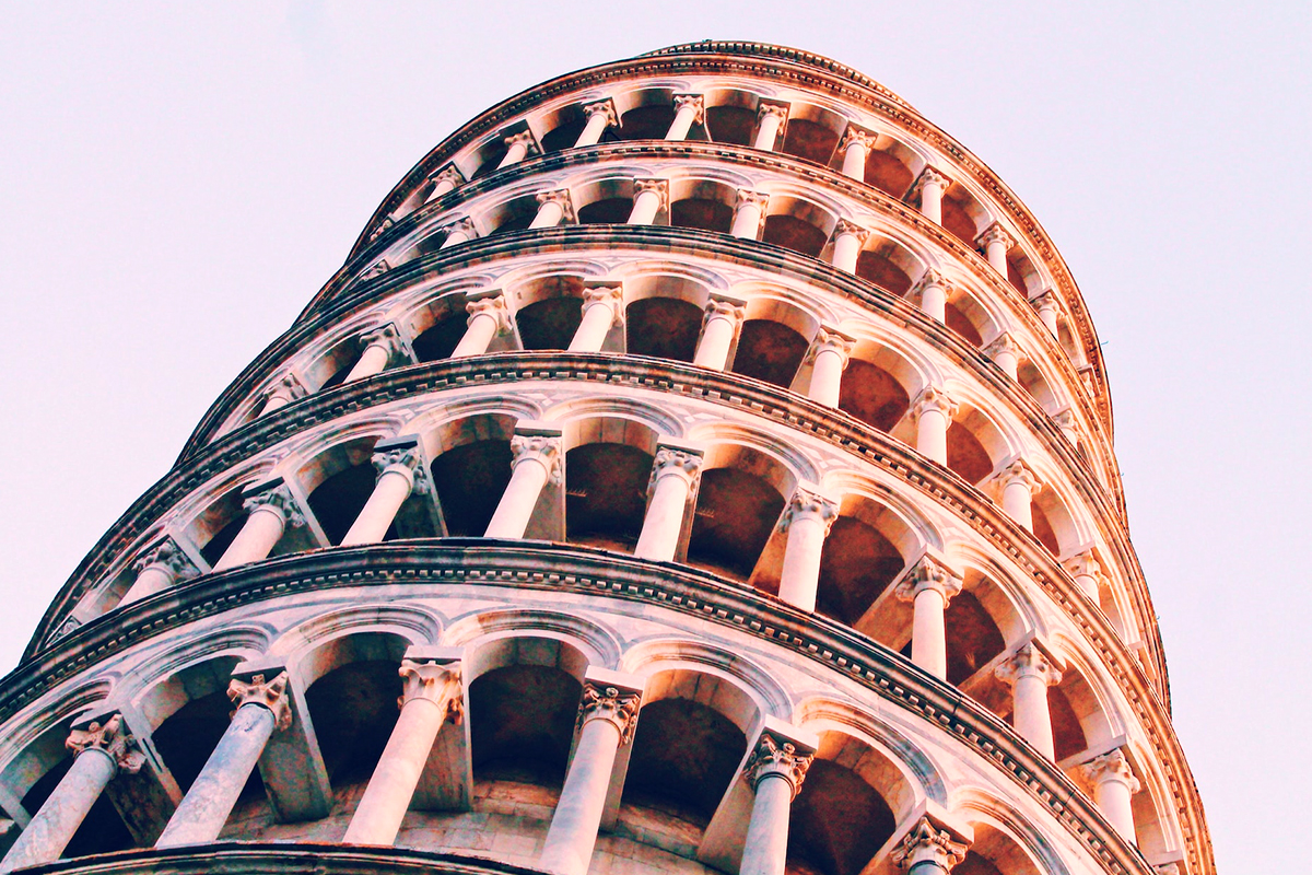 Close-up photograph of the marble columns and arcades of the Leaning Tower of Pisa