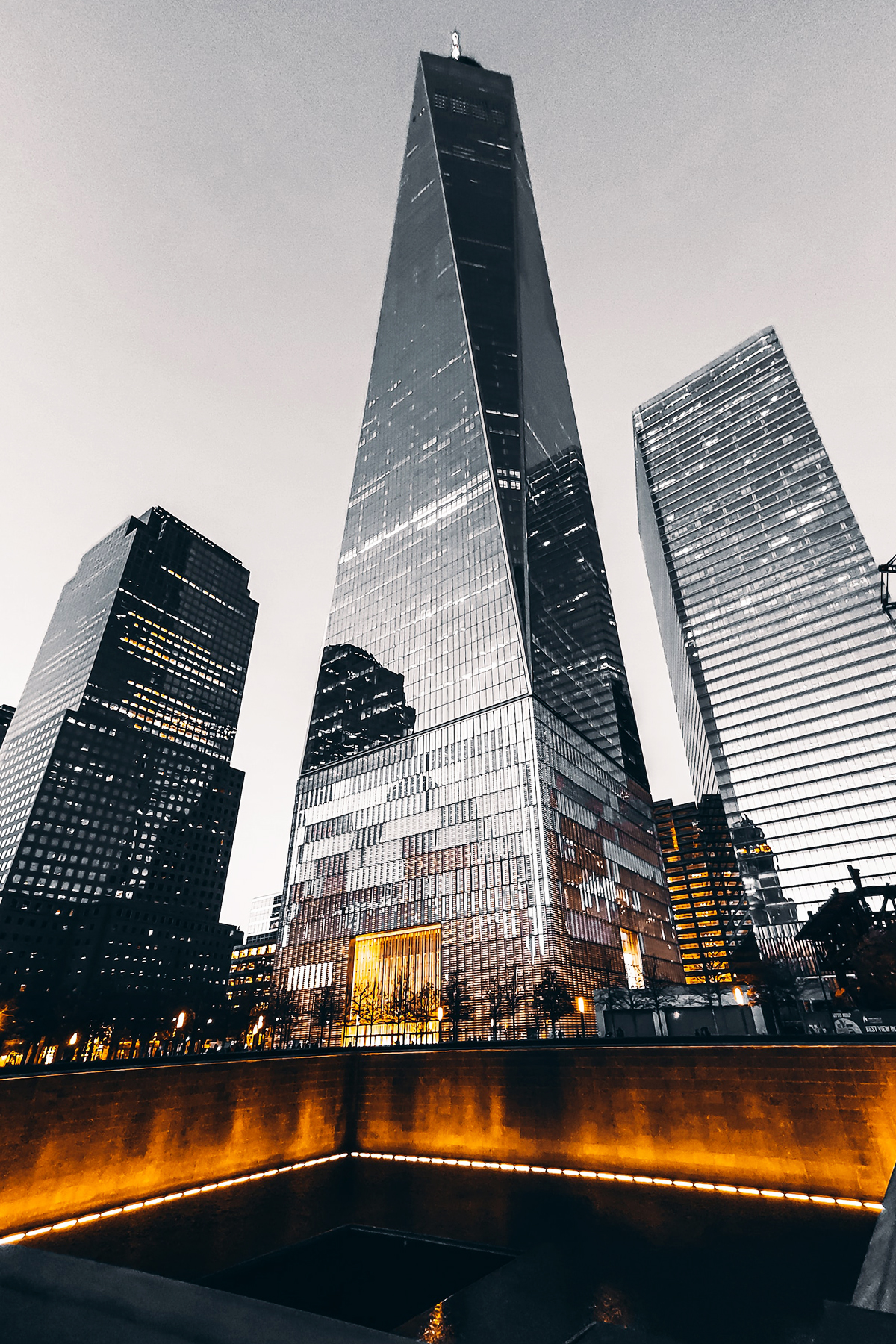 The tower rising above Lower Manhattan, its facets catching different light