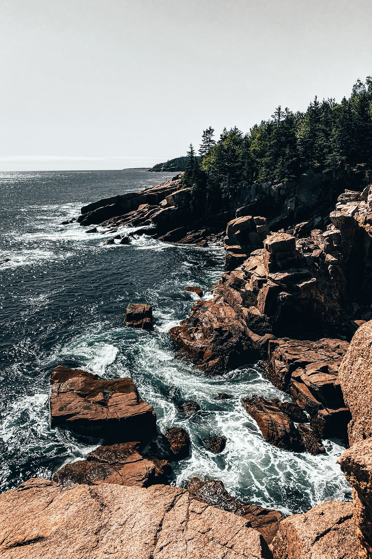 Atlantic waves breaking against pink granite on the coast of Acadia National Park